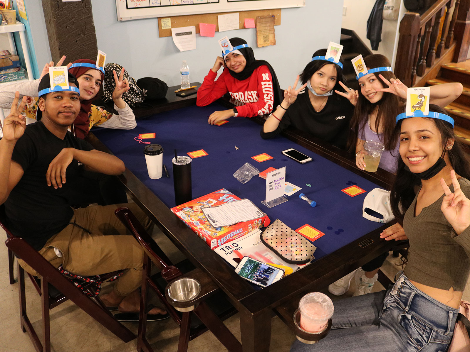Diverse group of students play Headbanz in the TRIO office