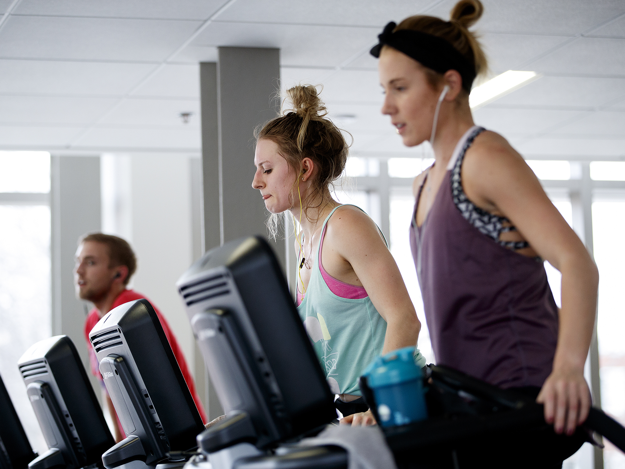 Students exercise on the step machines and ellipticals at the Rec & Wellness Center on East Campus. (photo by Craig Chandler | University Communication] 