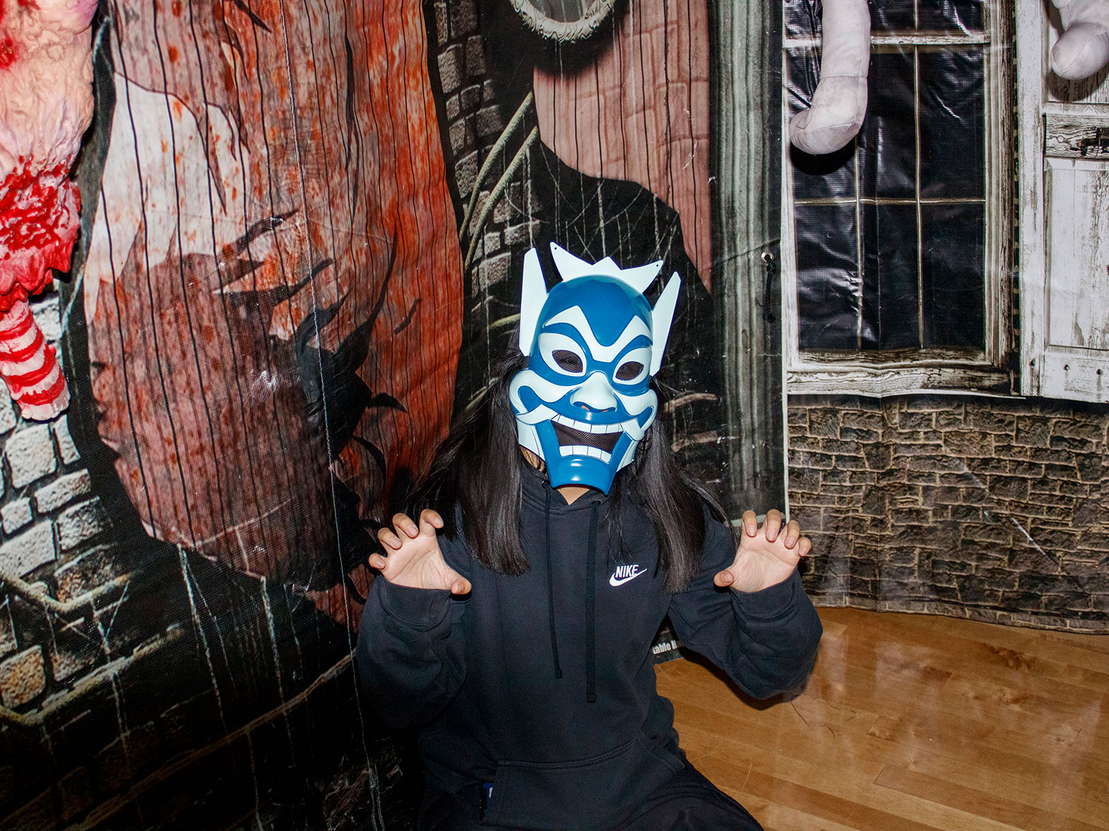 Student poses with a blue full face mask at the haunted house on East Campus on Oct. 20, 2022.