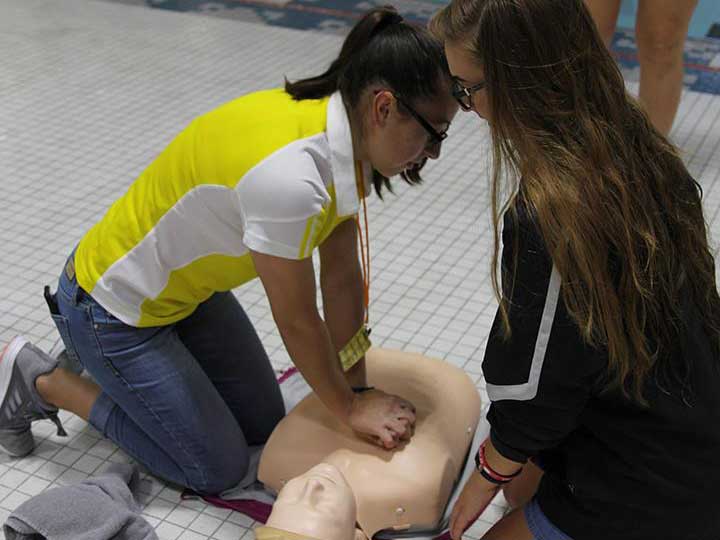 Student employees at Campus Recreation at the University of Nebraska-Lincoln practice CPR skills as part of staff training.