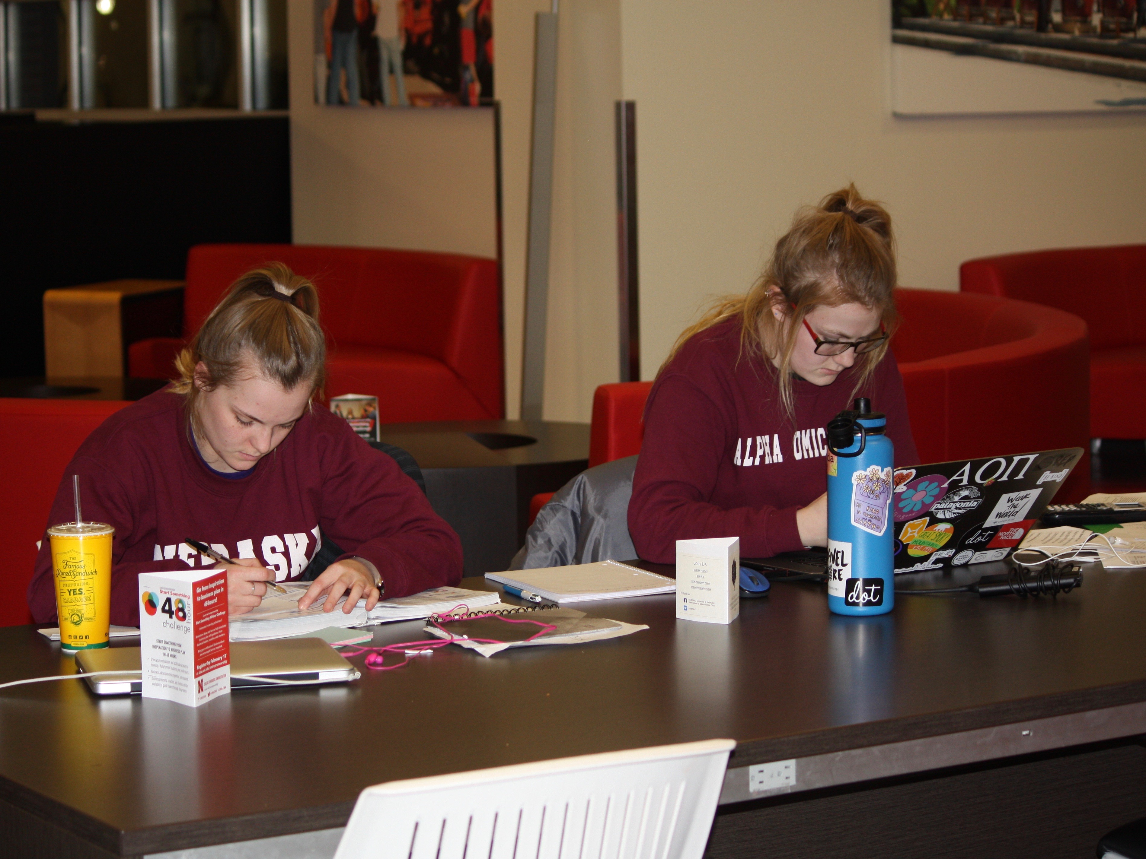 Members of Alpha Omicron Pi study in the Nebraska Union.