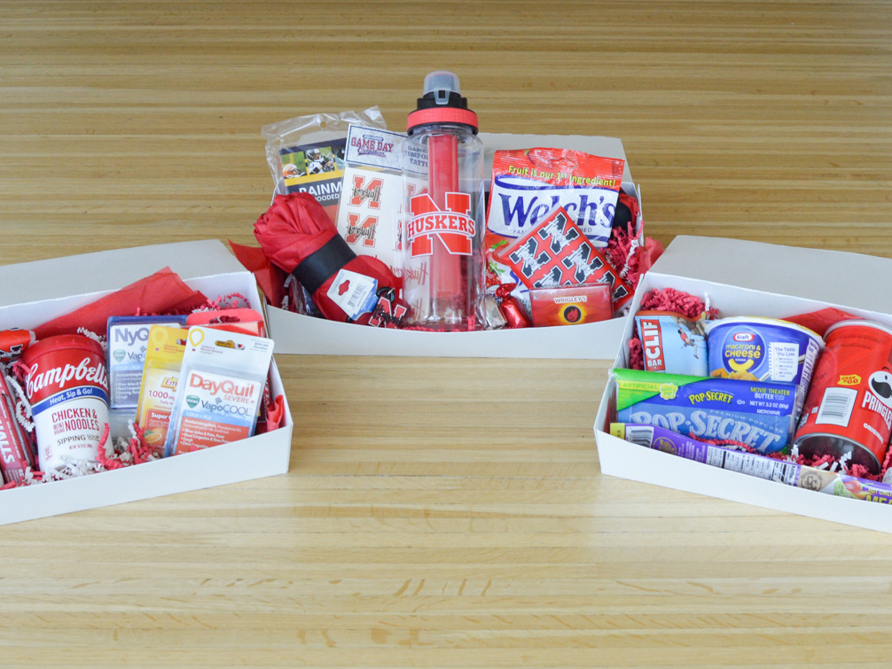 Care packages with an assortment of treats including snacks, Husker gear, and cold remedies.