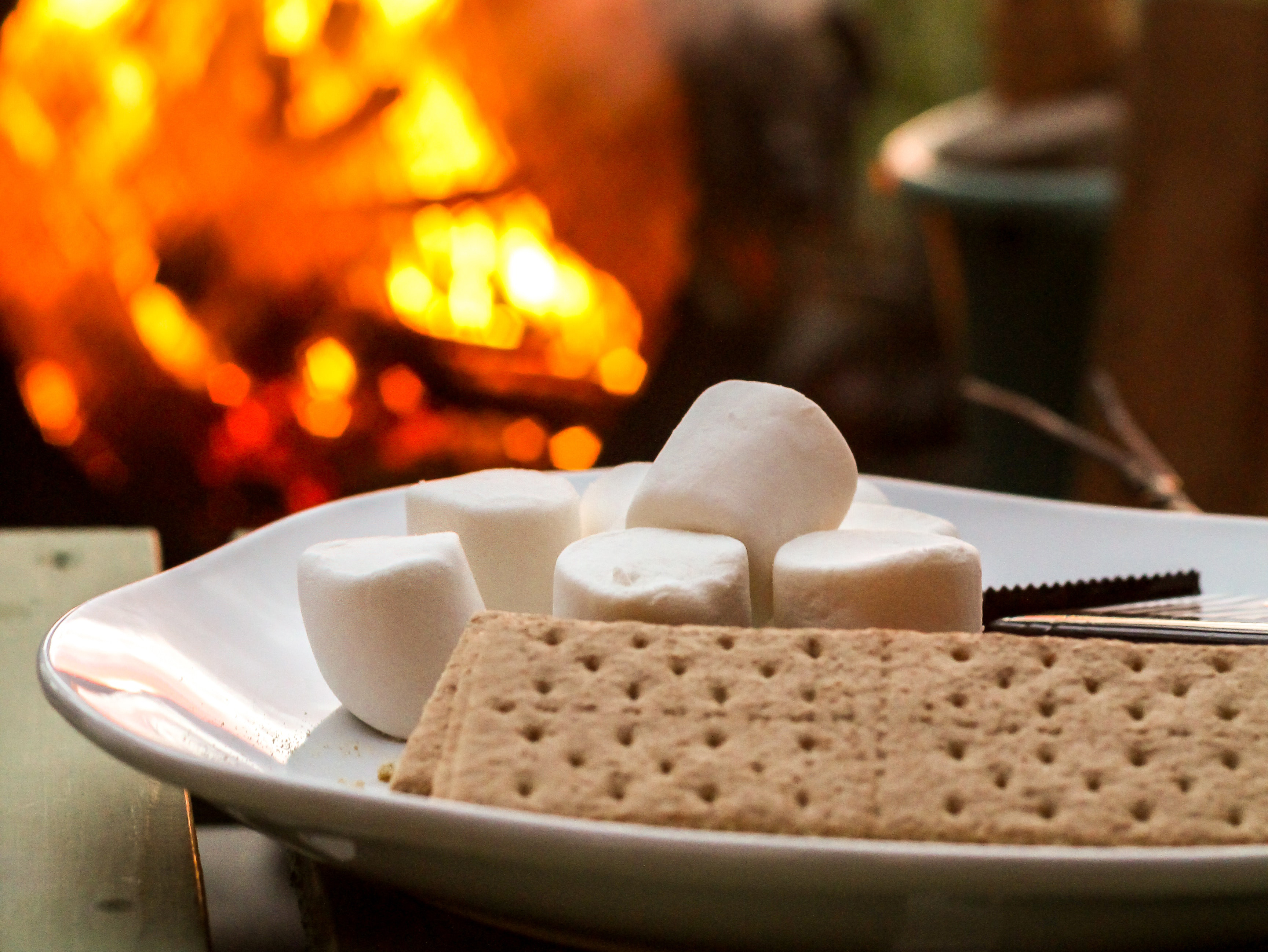Graham crackers, marshmallows, and chocolate are the key ingredients needed to make s'mores on an open fire. [Photo by Calvin Hanson from Pexels]