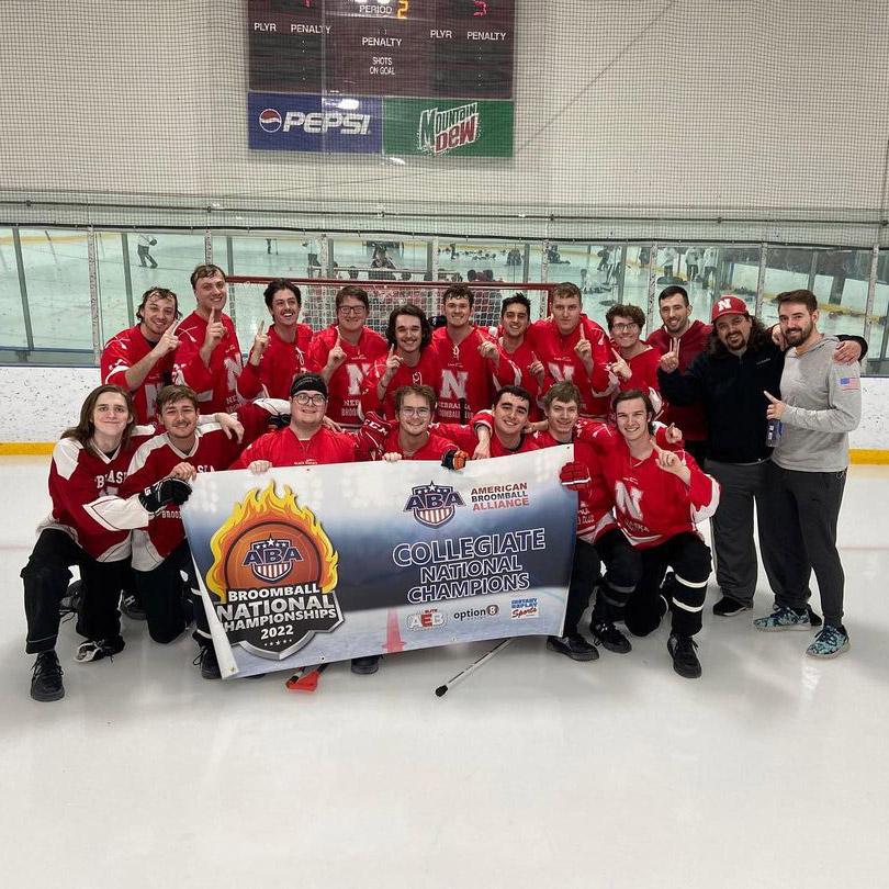 Intramural broomball team poses with national champions sign