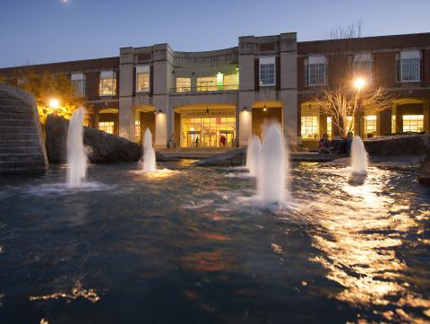 Broyhill Fountain at dusk, with Nebraska Union in the background.