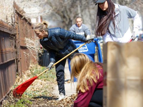 Keeleigh Thayn (in blue jacket) and her Gamma Phi Beta sorority sisters rake leaves along P street during the 2018 Big Event. More than 3,000 students, faculty and staff participated in the day of service.
