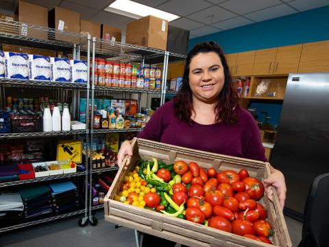 Morgan Smith, graduate research assistant, holds a tote of fresh vegetables at the Husker Pantry in August 2019. 