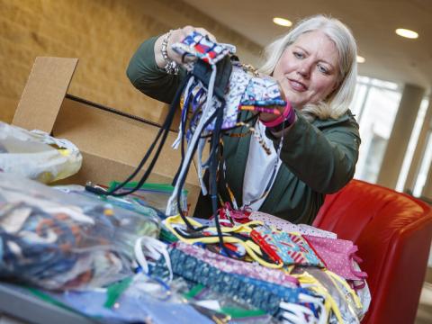 Veronica Riepe counts donated cloth masks before they're distributed to the nearly 1,000 university employees who continue to work on campus. 