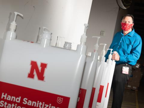 Jim Jackson, associate vice chancellor of University Operations, put a team together to solve the problem of efficiently distributing hand sanitizer across campus. They invented the large-capacity, free-standing dispenser station shown here. 