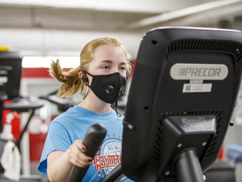 A student exercises on an elliptical machine in the Campus Rec Center at the University of Nebraska-Lincoln. [ Mike Jackson | Student Affairs ]