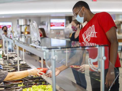 All masked up, students make lunch selections in the Cather Dining Center earlier this summer.