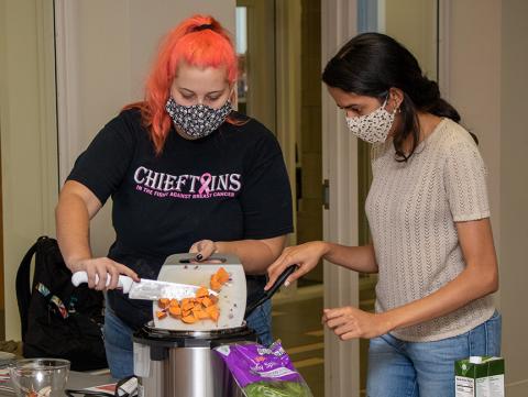 Two students prepare an Instapot recipe during at CookWell Class at the Rec & Wellness Center.