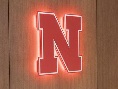 UNL's N-icon is illuminated largely on the wall in the Nebraska East Union.