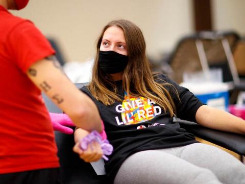Kacey Heidbrink, of Beatrice, listens to instructions while donating Oct. 27, 2020.