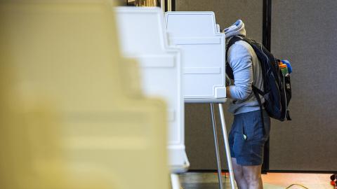 A student casts a ballot in Nebraska Union during the 2020 general election Nov. 3, 2020. [Craig Chandler | University Communication and Marketing]