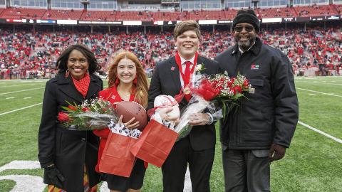 Newly crowned homecoming royalty Hannah-Kate Kinney (second from left) and Preston Kotik (third from left) are joined by Chancellor Rodney Bennett (right) and his wife, Temple (left), during the halftime ceremony. [Craig Chandler | University Communication and Marketing]