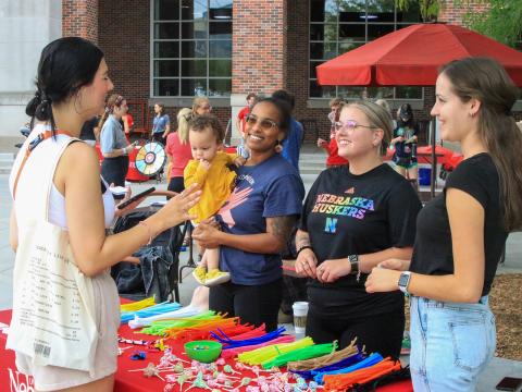 A student stops by the Counselor-in-Residence booth at the Wellness Fest on the Nebraska Union Plaza as part of Big Red Welcome.