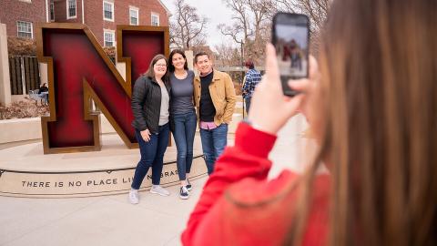 A prospective Husker and her family poses in front of the iconic "N" statue outside the Wick Alumni Center during Admitted Student Day on March 25. More than 930 prospective students attended, experiencing campus life first hand. [Jordan Opp | University Communication and Marketing]