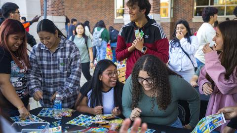 A large group of students play an enthusiastic game of Mexican Bingo at Fiesta on the Green. [Kristen Labadie | University Communication and Marketing ]