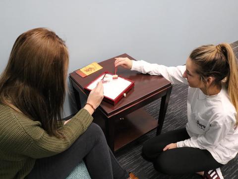 Two students play with a zen box.