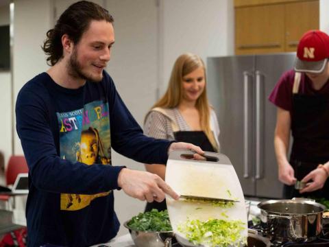Sterling Dorton slides celery into a pot during the Zero Waste cooking class at the University of Nebraska-Lincoln Recreation & Wellness Center on East Campus in Lincoln, Nebraska on Thursday, Sept. 19, 2019.