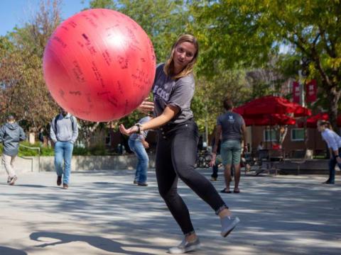 UNL students bounce a ball outside of the union during Big Red Resilience and Well-Being's "Recess" event on Monday, Oct. 14, 2019, in Lincoln, Nebraska.