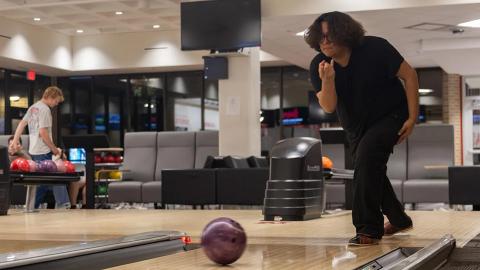 Enrique Acevedo, a freshman forensic science major, throws a bowling ball down a lane on Wednesday, March 20, 2024 at the Husker Bowling Center in the Nebraska East Union in Lincoln, Nebraska.  [Photo by Justin Diep | Daily Nebraskan]