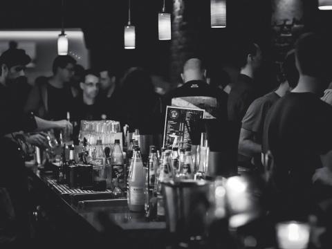 Black and white image of crowded bar scene