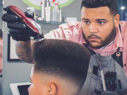 Nate Berks trims a client's hair inside Berks Barbershop.
