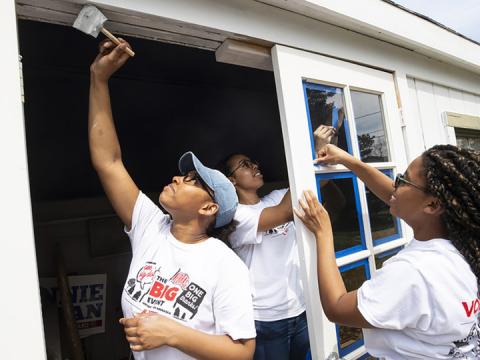 Members of the Minority Pre-Health Association paint a shed and clean up a yard during last April’s Big Event.
