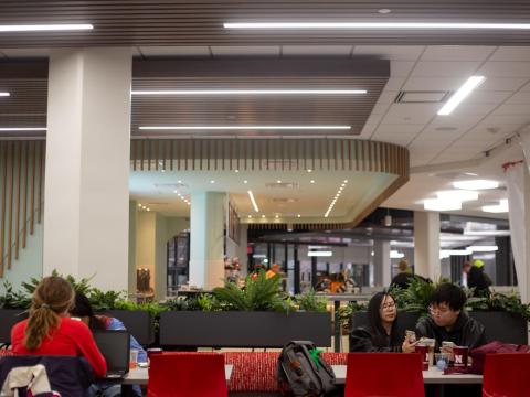 Cristal Kwan (left) shows Mike Nguyen (right) her phone in the newly renovated East Campus Union on Monday, March 9, 2020, in Lincoln, Nebraska.