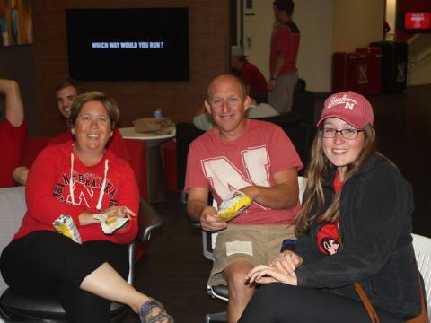 Family members watch the Nebraska football game together at Family Weekend