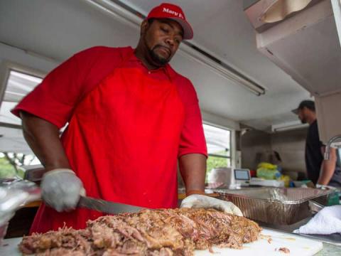 Charles Phillips slices brisket in his food truck, Mary Ellen's Food for the Soul. The truck was one of two available on the Nebraska Union Plaza on Aug. 20. | University Communication