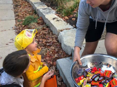 Child dressed as a firefighter participates in trick or treat at University of Nebraska-Lincoln