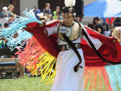 Native American dancer performs on the University of Nebraska-Lincoln green space at the UNITE powwow.