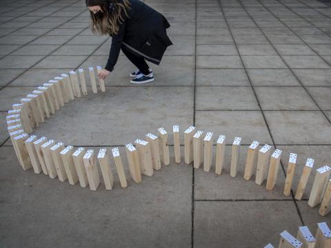   University of Nebraska-Lincoln senior Kateri Hartman, an advertising and public relations major from Wahoo, sets up some of the 70 dominos with the names of students who signed a pledge as part of The Civility Effect on Thursday at the Nebraska Union. As part of the project, five UNL students aim to teach people how to have productive, civil conversations. (FRANCIS GARDLER, Journal Star) 
