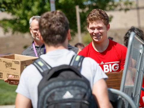University of Nebraska–Lincoln student Thomas Lilly (right) smiles as he and his roommate, Luke Haberman, carry a futon into Schramm Hall in August 2017. Students at Nebraska will move in from 8 a.m. to 4 p.m. the week of Aug. 13. | University Communication