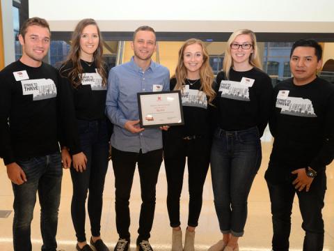 Mary Morton (second from right), Strive to Thrive Lincoln student, and classmates present Andrew Norman (center), executive director of The Bay, with grant award at final ceremony. 
