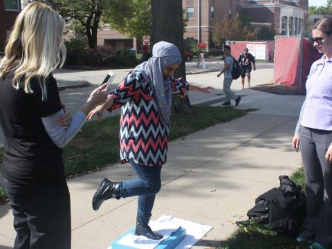 Student participates in balance test at PT Month event at University of Nebraska-Lincoln