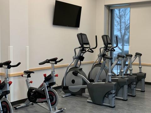 Upright exercise bikes and ellipticals in UNL residence halls' new fitness spaces.