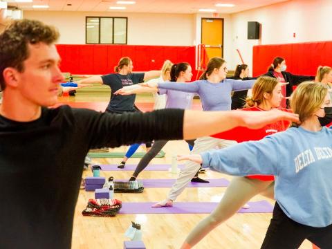 Students participate in yoga during free fitness class week