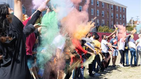 Participants throw color to start the Holi Festival on Saturday, April 1, 2023 at the Cather green-space.  [Photo by Charlee Sharack | Daily Nebraskan]
