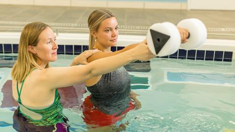 physical therapist working with patient in aquatherapy pool