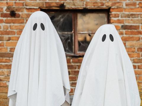 Two sheet-covered ghost costumes for Halloween.