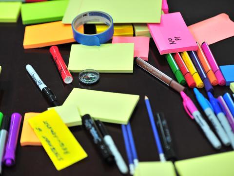 Post-it notes, markers, and pens on a desk. [pexels | photo by frans-van-heerden]