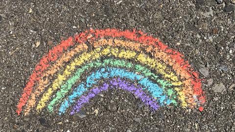 Rainbow drawn in chalk on asphalt. [photo by alex jackman | unsplash]